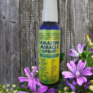 Amazing Miracle Spray in front of weathered board with purple flowers