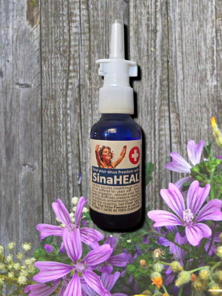 Sinaheal 2 SinaHEAL bottle in front of wood background with purple flowers